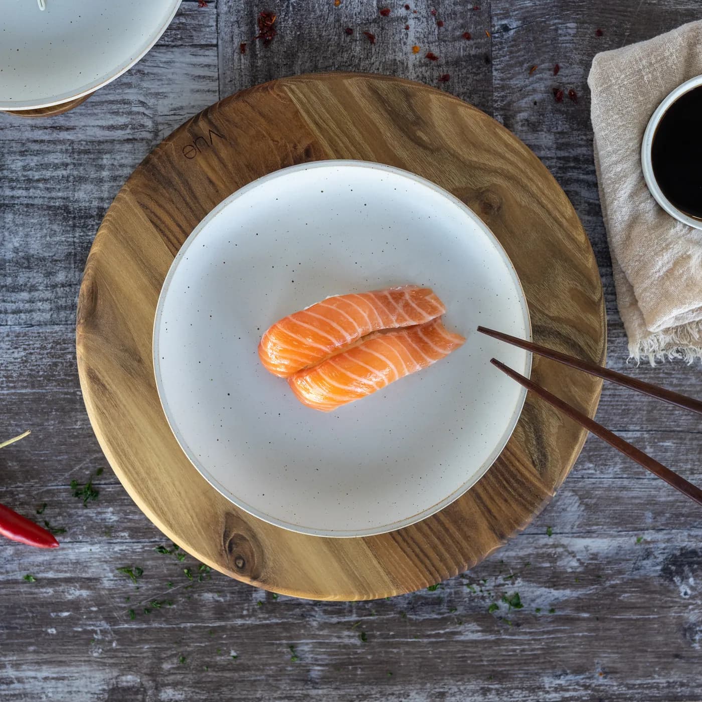 A single piece of Sushi Ari salmon nigiri on a wooden board